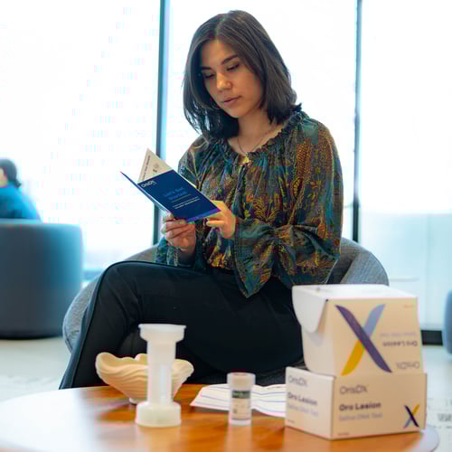 Woman Reading Oro Lesion Test Kit
